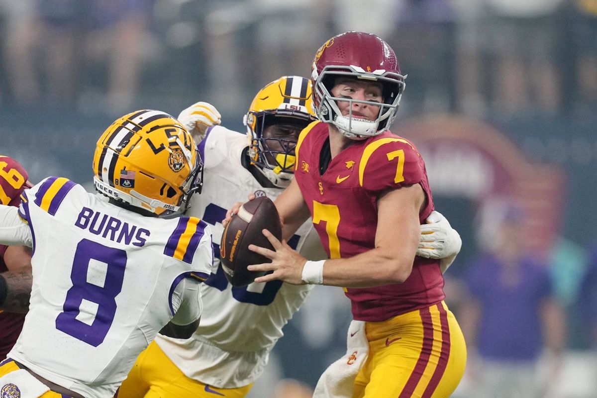 Sep 1, 2024; Paradise, Nevada, USA; Southern California Trojans quarterback Miller Moss (7) is pressured by LSU Tigers safety Major Burns (8) and tight end Gabe Leonards (85) in the first half at Allegiant Stadium. Mandatory Credit: Kirby Lee-USA TODAY Sports