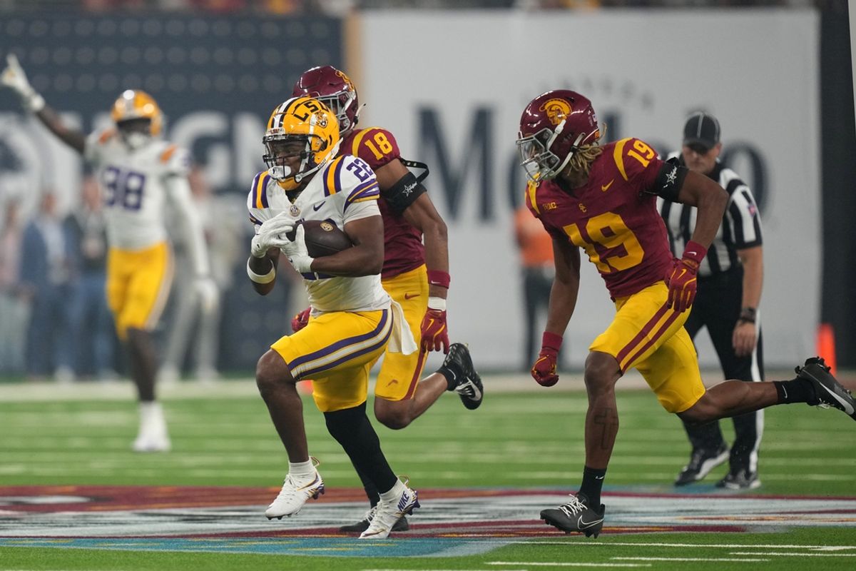 Sep 1, 2024; Paradise, Nevada, USA;  LSU Tigers running back John Emery Jr. (22) carries the ball against  Southern California Trojans cornerback John Humphrey (19) in the second half at Allegiant Stadium. Mandatory Credit: Kirby Lee-Imagn Images