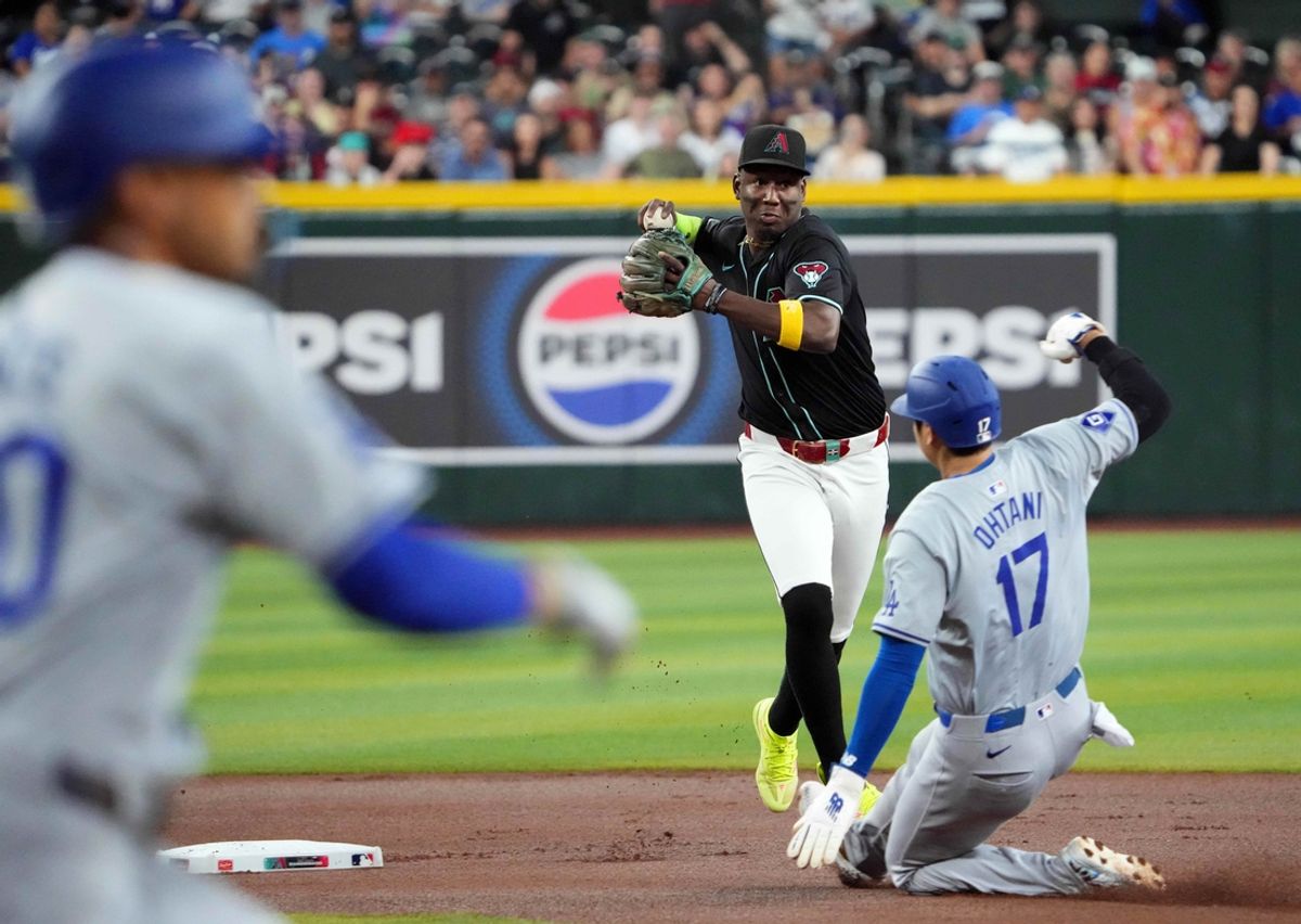 Sep 2, 2024; Phoenix, Arizona, USA; Arizona Diamondbacks shortstop Geraldo Perdomo (2) throws to first to double up Los Angeles Dodgers shortstop Mookie Betts (50) after forcing out Los Angeles Dodgers two-way player Shohei Ohtani (17) at second during the first inning at Chase Field. Mandatory Credit: Joe Camporeale-USA TODAY Sports