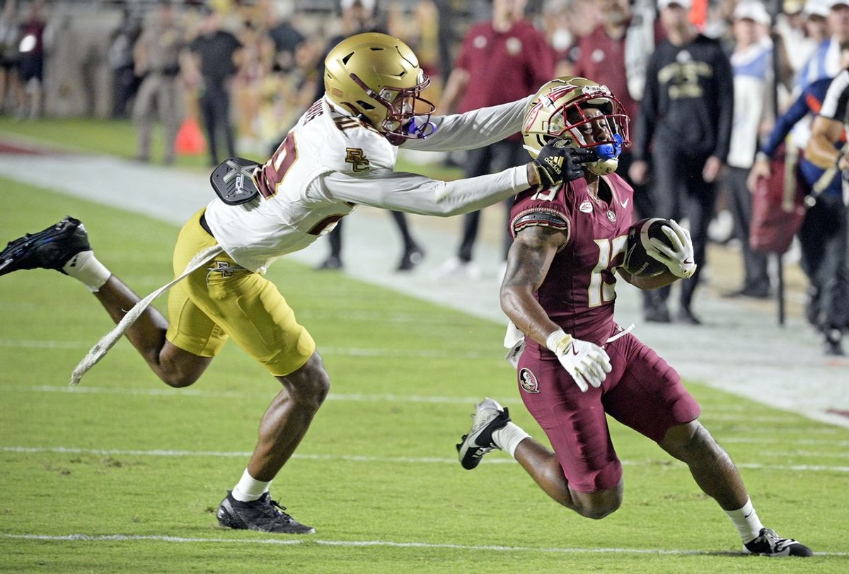 Sep 2, 2024; Tallahassee, Florida, USA; Florida State Seminoles running back Jaylin Lucas (13) is tackled by Boston College Eagles defensive back Carter Davis (28) during the first half at Doak S. Campbell Stadium. Mandatory Credit: Melina Myers-Imagn Images