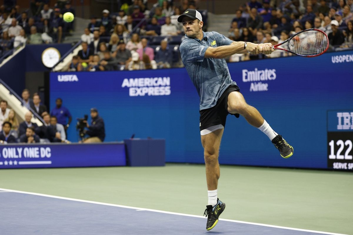 Sep 2, 2024; Flushing, NY, USA; Tommy Paul (USA) leaps to hit a backhand against Jannik Sinner (ITA)(not pictured) in a men's singles match on day eight of the 2024 U.S. Open tennis tournament at USTA Billie Jean King National Tennis Center. Mandatory Credit: Geoff Burke-Imagn Images
