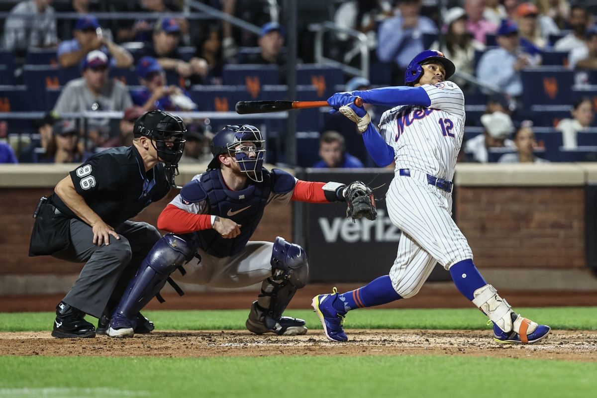 Sep 3, 2024; New York City, New York, USA;  New York Mets shortstop Francisco Lindor (12) hits a two-run home run in the third inning against the Boston Red Sox at Citi Field. Mandatory Credit: Wendell Cruz-Imagn Images