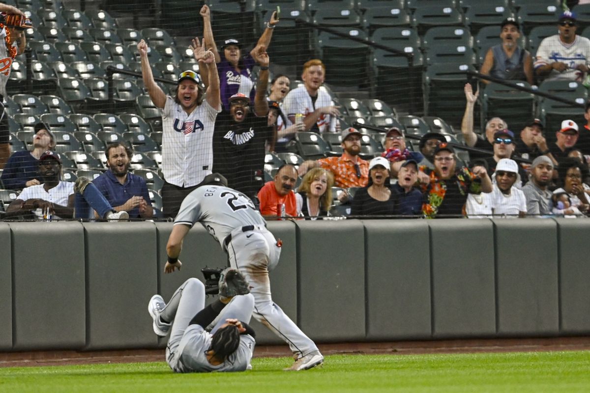 Sep 3, 2024; Baltimore, Maryland, USA;  Chicago White Sox outfielder Miguel Vargas (20) and  outfielder Andrew Benintendi (23) react after colliding on Baltimore Orioles designated hitter Eloy Jiménez (not pictured) second inning fly ball  at Oriole Park at Camden Yards. Mandatory Credit: Tommy Gilligan-Imagn Images
