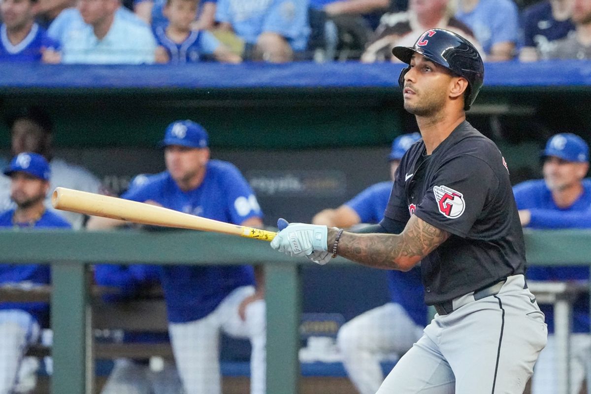 Sep 3, 2024; Kansas City, Missouri, USA; Cleveland Guardians shortstop Brayan Rocchio (4) hits a one-run sacrifice against the Kansas City Royals in the second inning at Kauffman Stadium. Mandatory Credit: Denny Medley-Imagn Images