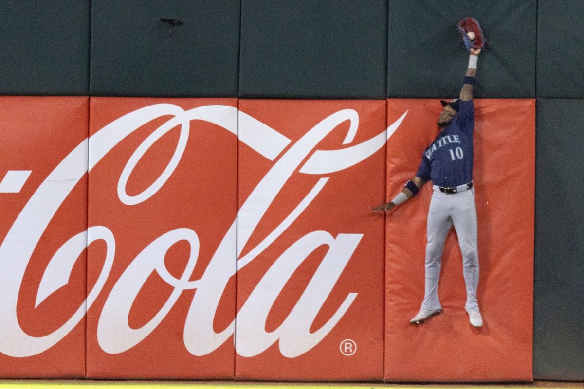 Sep 3, 2024; Oakland, California, USA; Seattle Mariners right fielder Victor Robles (10) leaps to catch a deep fly ball by Oakland Athletics third baseman Max Schuemann during the fifth inning at Oakland-Alameda County Coliseum. Robles then doubled up Tristan Gray (16) at first base. Mandatory Credit: D. Ross Cameron-Imagn Images
