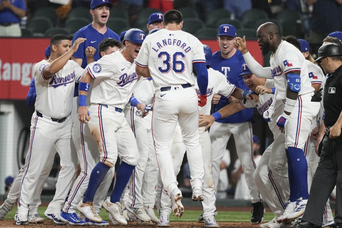 Sep 3, 2024; Arlington, Texas, USA; Texas Rangers center fielder Wyatt Langford (36) arrives home to teammates on his grand slam walk-off against the New York Yankees during the ninth inning at Globe Life Field. Mandatory Credit: Jim Cowsert-Imagn Images