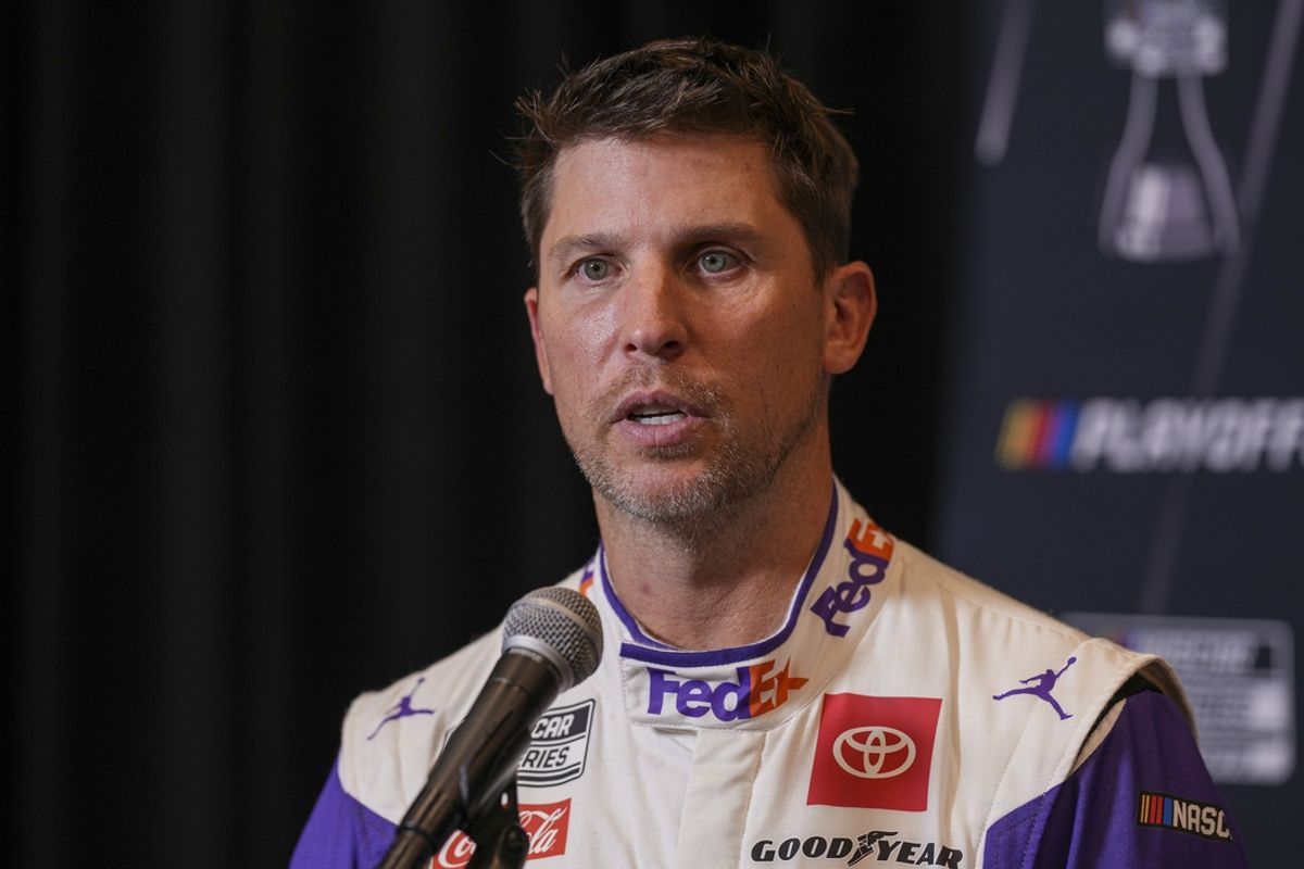 Sep 4, 2024; Charlotte, North Carolina, USA;  Denny Hamlin speaks to media members during the NASCAR Playoffs Media Day at the Charlotte Convention Center. Mandatory Credit: Jim Dedmon-Imagn Images
