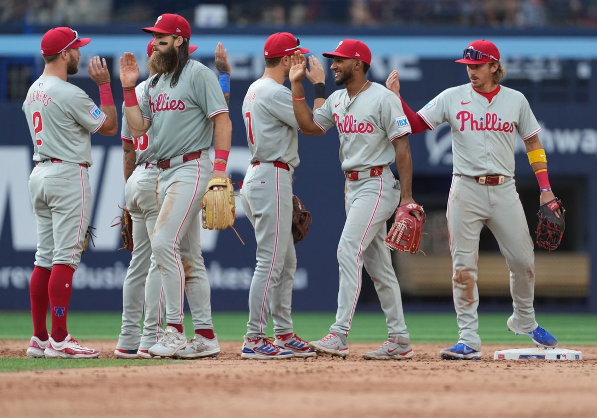 Sep 4, 2024; Toronto, Ontario, CAN; Philadelphia Phillies left fielder Brandon Marsh (16) celebrates the win with third baseman Kody Clemens (2) against the Toronto Blue Jays at the end of the ninth inning at Rogers Centre. Mandatory Credit: Nick Turchiaro-Imagn Images