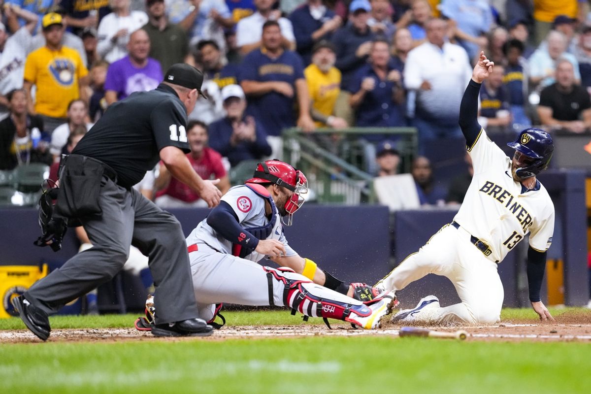 Sep 4, 2024; Milwaukee, Wisconsin, USA;  Milwaukee Brewers catcher Eric Haase (13) is tagged by St. Louis Cardinals catcher Ivan Herrera (48) while trying to score during the third inning at American Family Field. Mandatory Credit: Jeff Hanisch-Imagn Images