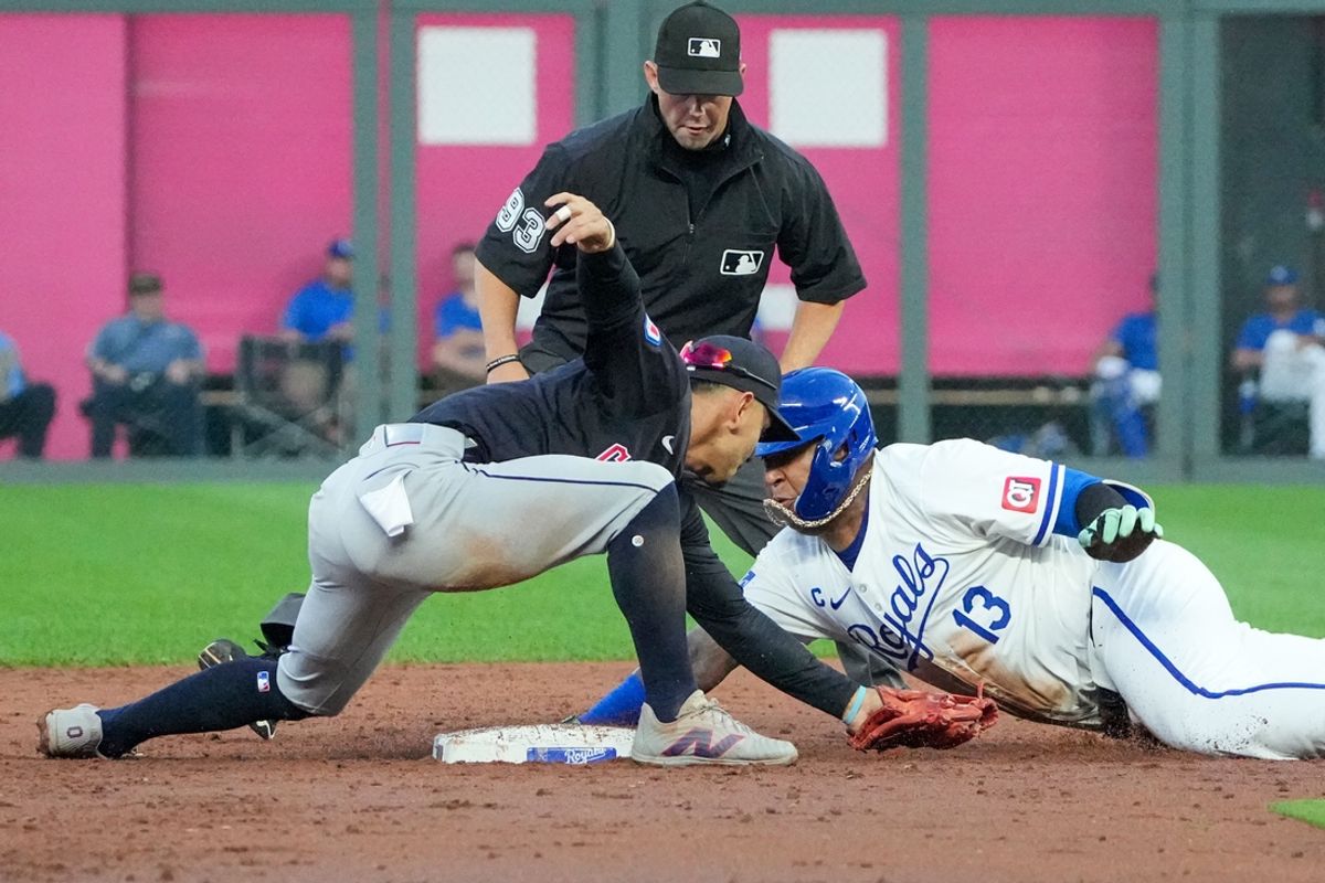 Sep 4, 2024; Kansas City, Missouri, USA; Cleveland Guardians second baseman Andrés Giménez (0) misses the tag as Kansas City Royals first baseman Salvador Perez (13) reaches second on a double in the third inning at Kauffman Stadium. Mandatory Credit: Denny Medley-Imagn Images