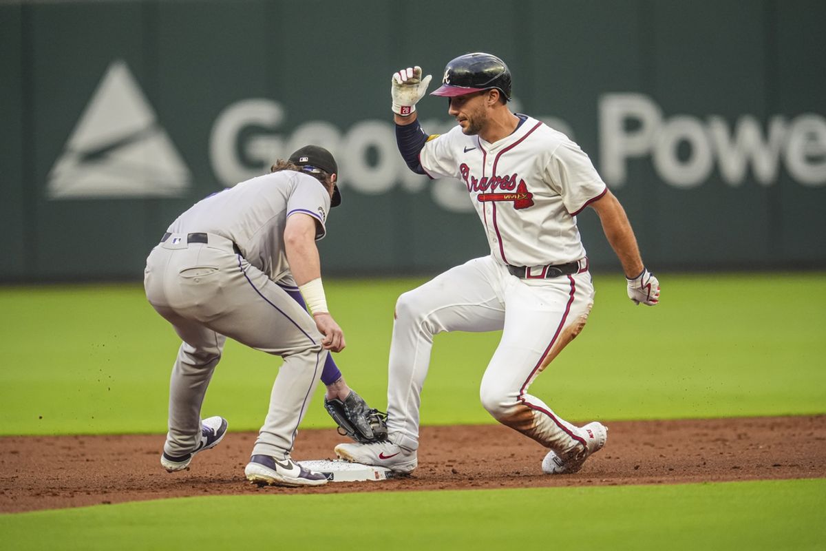Sep 4, 2024; Cumberland, Georgia, USA; Atlanta Braves first baseman Matt Olson (28) is safe ahead of the tag by Colorado Rockies second baseman after hitting a double during the first inning at Truist Park. Mandatory Credit: Dale Zanine-Imagn Images
