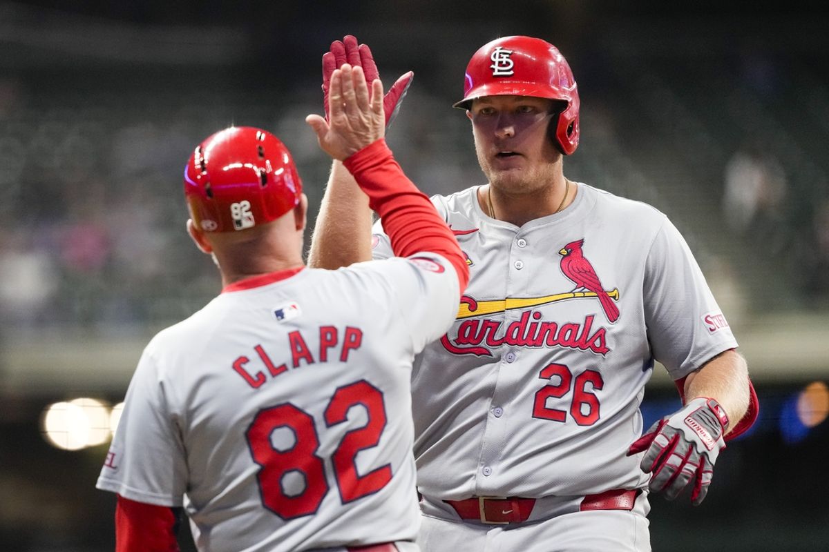 Sep 4, 2024; Milwaukee, Wisconsin, USA;  St. Louis Cardinals pinch hitter Luken Baker (26) high fives first base coach Stubby Clapp (82) after driving in a run during the tenth inning against the Milwaukee Brewers at American Family Field. Mandatory Credit: Jeff Hanisch-Imagn Images