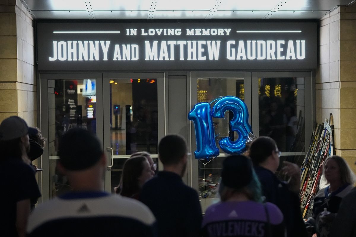 Sep 4, 2024; Columbus, OH, USA; Mourners gather for a candlelight vigil to remember Columbus Blue Jackets forward Johnny Gaudreau at Nationwide Arena. Gaudreau, along with his brother, Matthew, died in a bicycle crash last week. Mandatory Credit: Adam Cairns-Imagn Images via Columbus Dispatch/USA TODAY Network