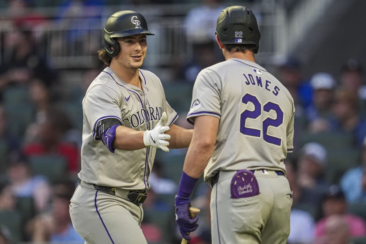 Sep 5, 2024; Cumberland, Georgia, USA; Colorado Rockies center fielder Brenton Doyle (9) reacts with left fielder Nolan Jones (22) after hitting a home run against the Atlanta Braves during the second inning at Truist Park. Mandatory Credit: Dale Zanine-Imagn Images