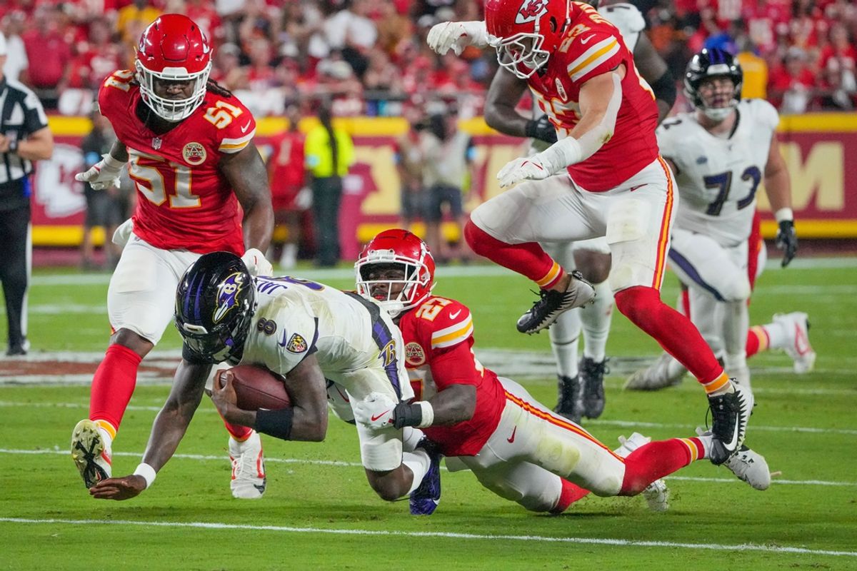 Sep 5, 2024; Kansas City, Missouri, USA; Baltimore Ravens quarterback Lamar Jackson (8) runs the ball as Kansas City Chiefs safety Chamarri Conner (27) makes the tackle during the first half at GEHA Field at Arrowhead Stadium. Mandatory Credit: Denny Medley-Imagn Images