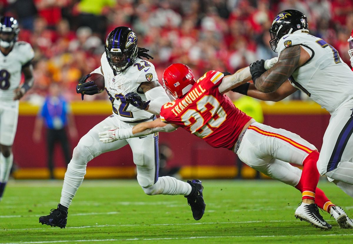Sep 5, 2024; Kansas City, Missouri, USA; Baltimore Ravens running back Derrick Henry (22) runs the ball against Kansas City Chiefs linebacker Drue Tranquill (23) during the first half at GEHA Field at Arrowhead Stadium. Mandatory Credit: Jay Biggerstaff-Imagn Images