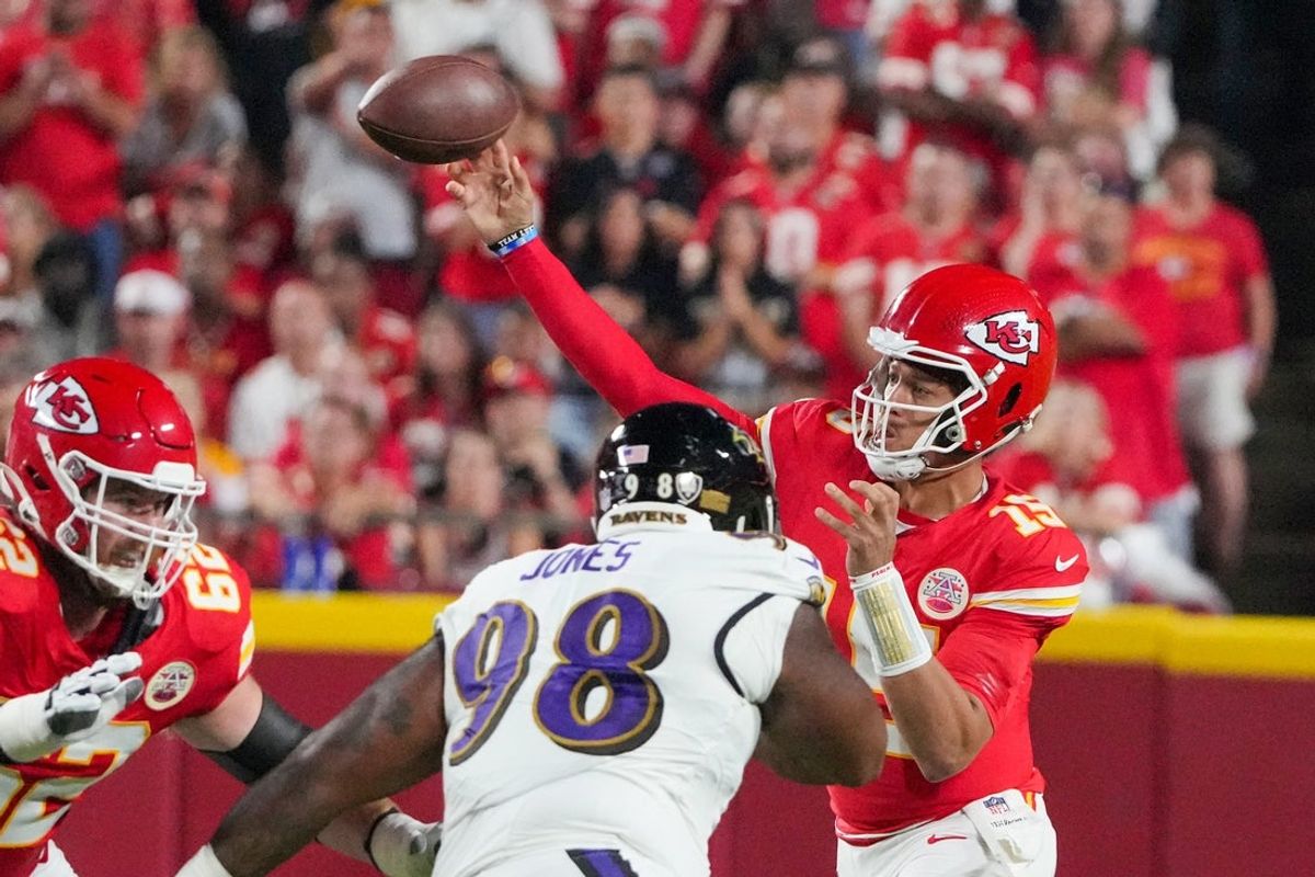 Sep 5, 2024; Kansas City, Missouri, USA; Kansas City Chiefs quarterback Patrick Mahomes (15) throws a pass as Baltimore Ravens defensive tackle Travis Jones (98) defends during the first half at GEHA Field at Arrowhead Stadium. Mandatory Credit: Denny Medley-Imagn Images