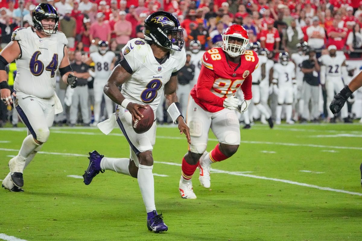 Sep 5, 2024; Kansas City, Missouri, USA; Baltimore Ravens quarterback Lamar Jackson (8) runs the ball as Kansas City Chiefs defensive tackle Tershawn Wharton (98) chases during the second half at GEHA Field at Arrowhead Stadium. Mandatory Credit: Denny Medley-Imagn Images