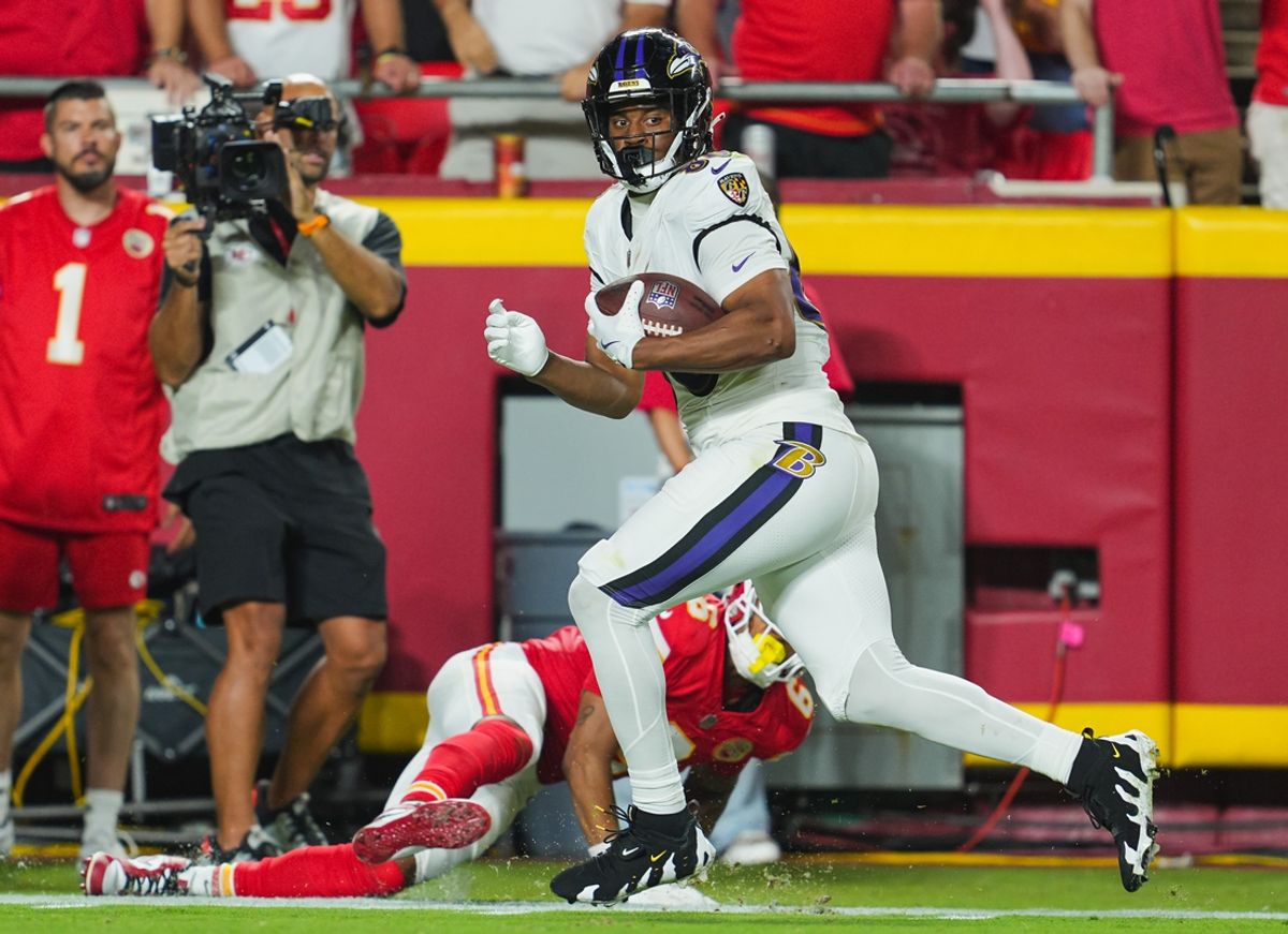 Kansas City, Missouri, USA; Baltimore Ravens tight end Isaiah Likely (80) scores a touchdown against Kansas City Chiefs safety Bryan Cook (6) during the second half at GEHA Field at Arrowhead Stadium. Mandatory Credit: Jay Biggerstaff-Imagn Images