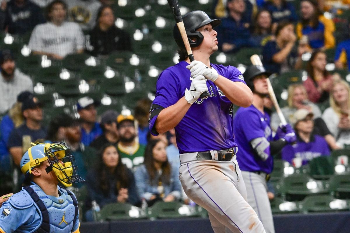 Sep 6, 2024; Milwaukee, Wisconsin, USA; Colorado Rockies first baseman Michael Toglia (4) hits a three-run home run in the sixth inning as Milwaukee Brewers catcher William Contreras (24) looks on at American Family Field. Mandatory Credit: Benny Sieu-Imagn Images