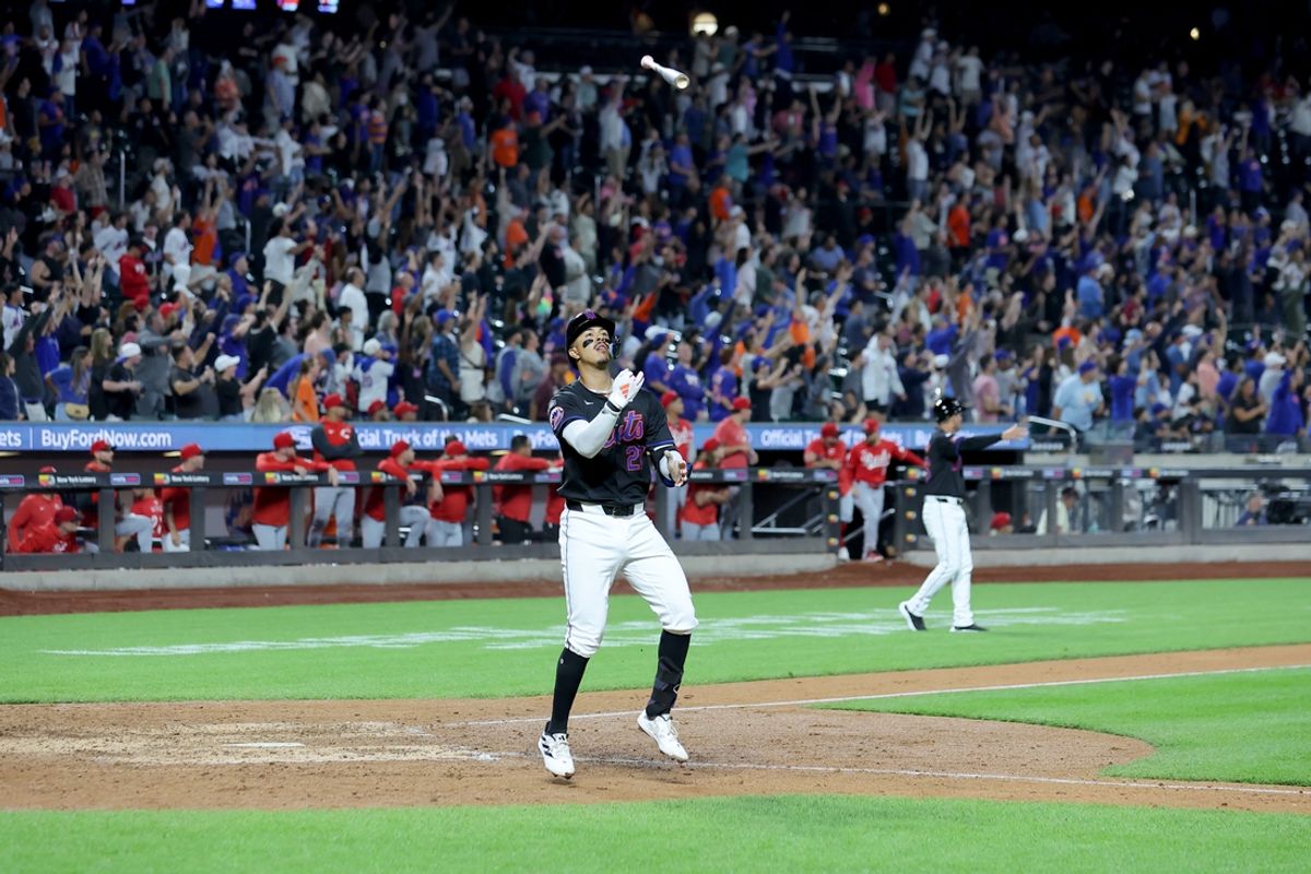 Sep 6, 2024; New York City, New York, USA; New York Mets third baseman Mark Vientos (27) tosses his bat into the air after hitting a tenth inning walkoff two run home run against the Cincinnati Reds at Citi Field. Mandatory Credit: Brad Penner-Imagn Images