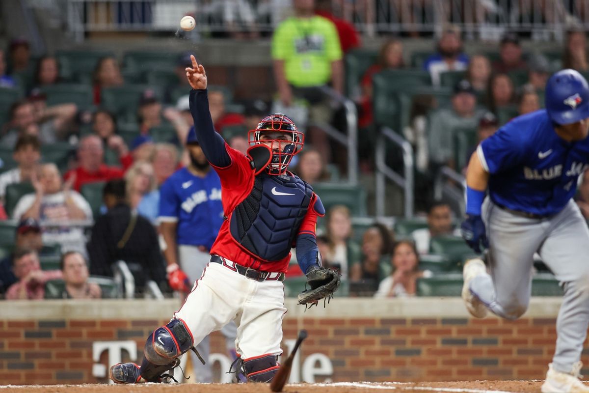 Sep 6, 2024; Atlanta, Georgia, USA; Atlanta Braves catcher Travis d'Arnaud (16) throws a runner out at first after a strikeout against the Toronto Blue Jays in the seventh inning at Truist Park. Mandatory Credit: Brett Davis-Imagn Images