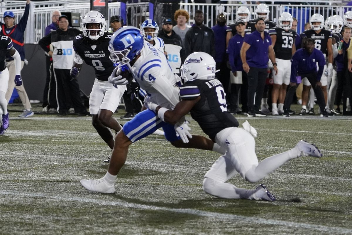 Sep 6, 2024; Evanston, Illinois, USA; Duke Blue Devils wide receiver Eli Pancol (4) catches a touchdown pass as Northwestern Wildcats defensive back Braden Turner (9) defends him during the first half at Lanny and Sharon Martin Stadium. Mandatory Credit: David Banks-Imagn Images