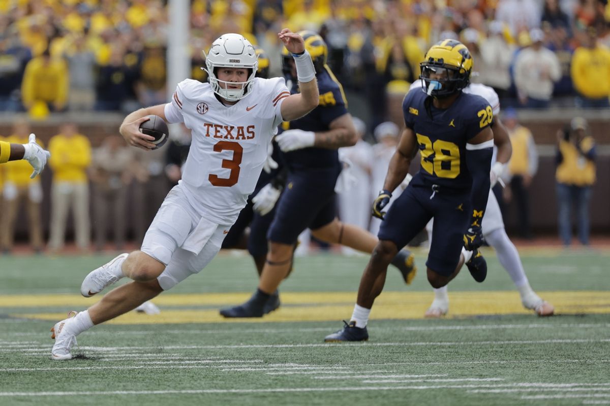 Sep 7, 2024; Ann Arbor, Michigan, USA; Texas Longhorns quarterback Quinn Ewers (3) rushes in the first half against the Michigan Wolverines at Michigan Stadium. Mandatory Credit: Rick Osentoski-Imagn Images