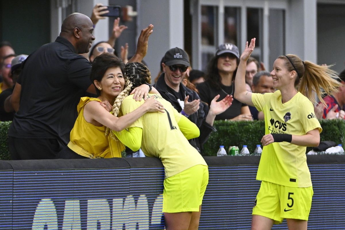 Sep 7, 2024; Washington, District of Columbia, USA; Washington Spirit forward Trinity Rodman (2) celebrates with owner Michel Kang and Washington Commanders owner Magic Johnson after scoring a goal against Portland Thorns FC during the second half at Audi Field. Mandatory Credit: Brad Mills-Imagn Images