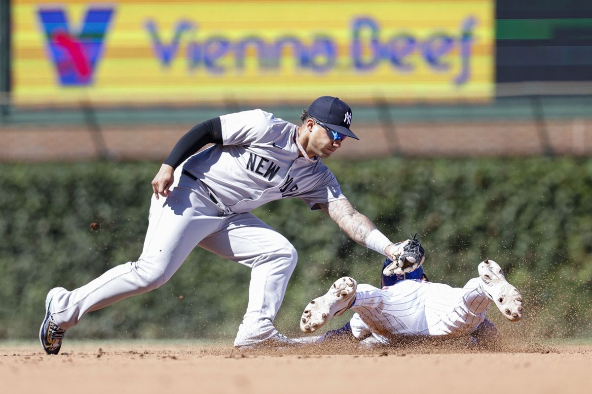 Sep 7, 2024; Chicago, Illinois, USA; Chicago Cubs second baseman Nico Hoerner (2) is caught stealing second base by New York Yankees second baseman Gleyber Torres (25) during the fourth inning at Wrigley Field. Mandatory Credit: Kamil Krzaczynski-Imagn Images