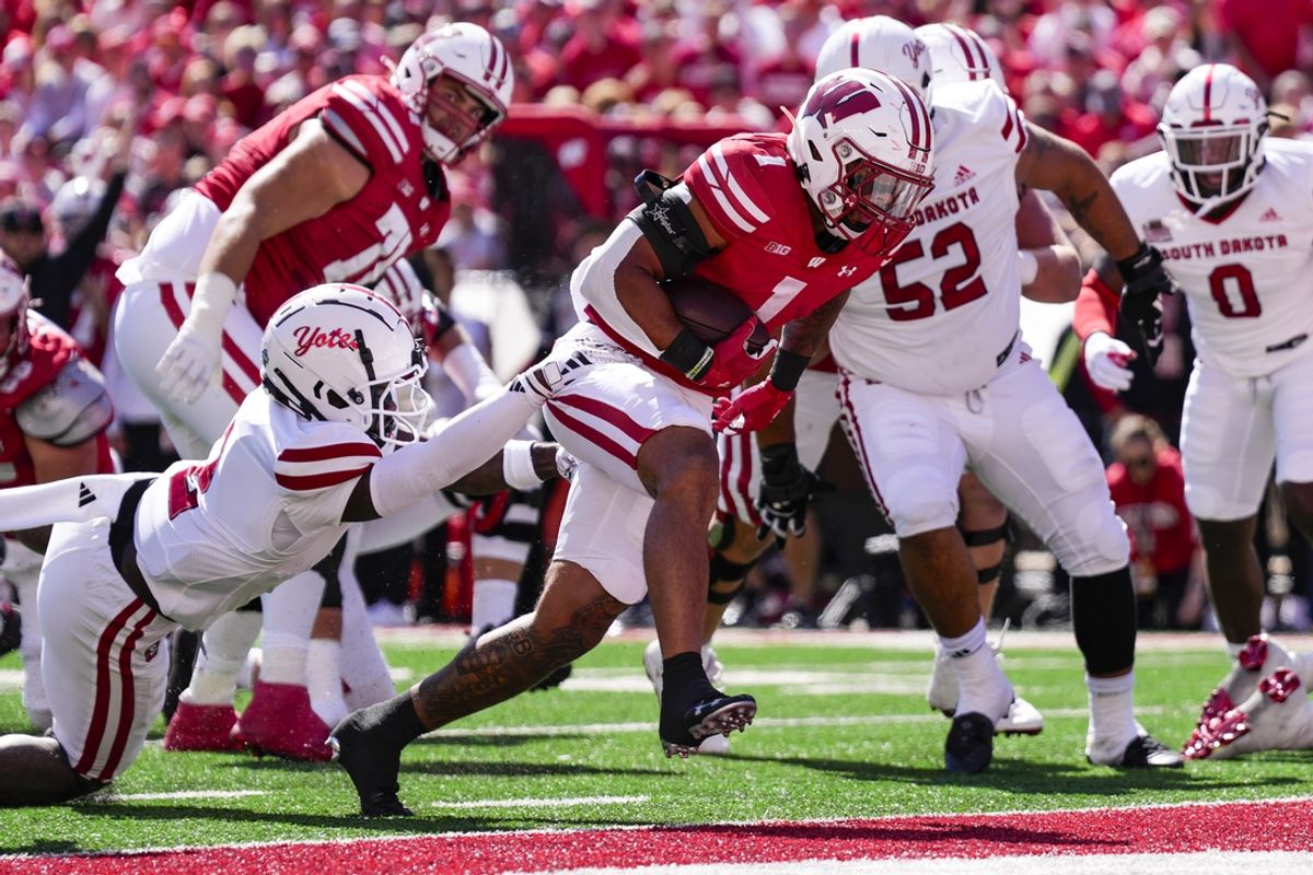 Sep 7, 2024; Madison, Wisconsin, USA;  Wisconsin Badgers running back Chez Mellusi (1) rushes for a touchdown during the first quarter against the South Dakota Coyotes at Camp Randall Stadium. Mandatory Credit: Jeff Hanisch-Imagn Images