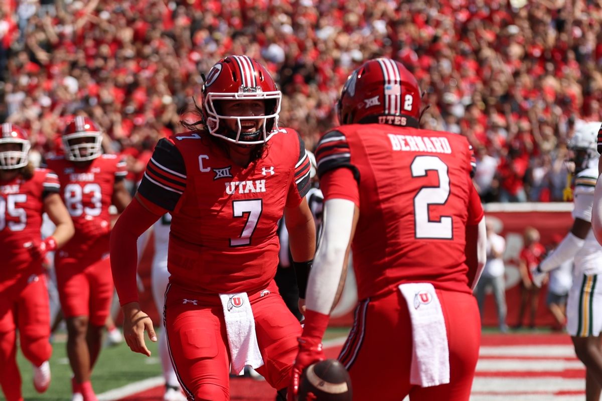 Sep 7, 2024; Salt Lake City, Utah, USA; Utah Utes quarterback Cameron Rising (7) and running back Micah Bernard (2) celebrate a touchdown against the Baylor Bears during the first quarter at Rice-Eccles Stadium. Mandatory Credit: Rob Gray-Imagn Images