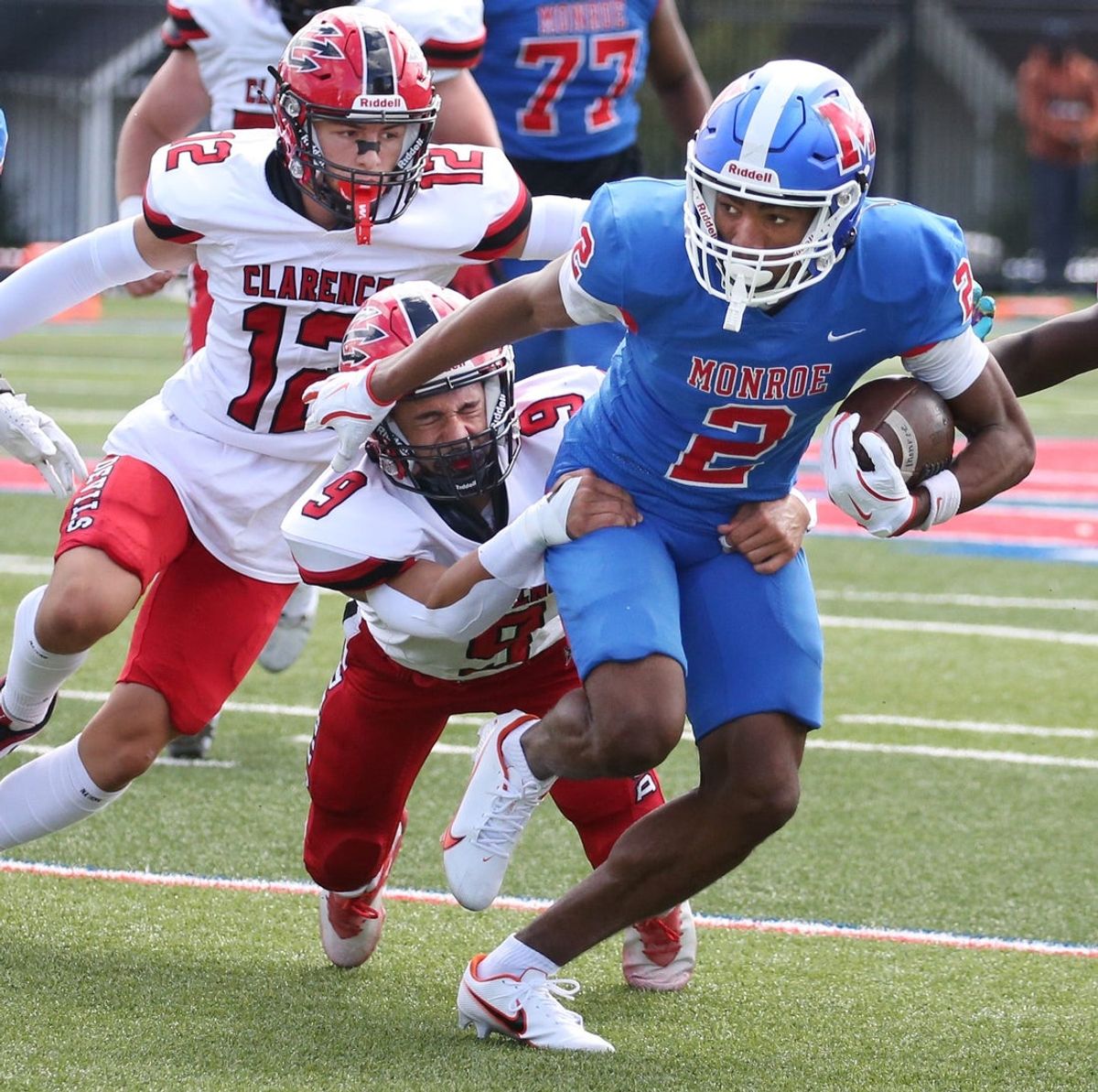 Monroe wide receiver Messiah Hampton gains yards after the catch as he drags Clarence's A.J. Didas down the field during their season opening game Saturday, Sept. 7, 2024 at Monroe High School.
