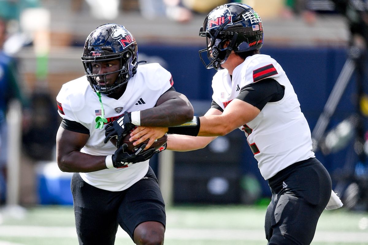 Sep 7, 2024; South Bend, Indiana, USA; Northern Illinois Huskies quarterback Ethan Hampton (2) hands off to running back Antario Brown (1) in the first quarter against the Notre Dame Fighting Irish at Notre Dame Stadium. Mandatory Credit: Matt Cashore-Imagn Images