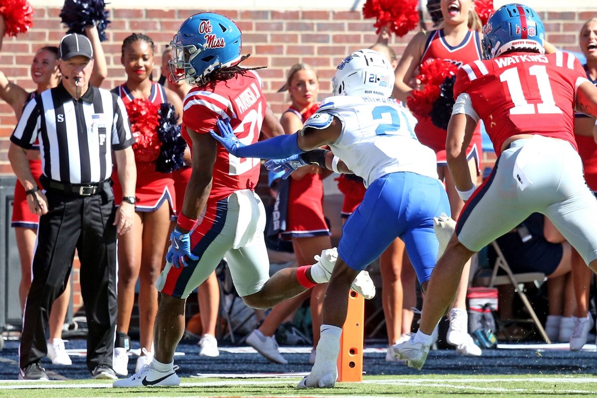 Sep 7, 2024; Oxford, Mississippi, USA; Mississippi Rebels running back Henry Parrish Jr. (21) runs the ball for a for a touchdown as Middle Tennessee Blue Raiders defensive back Abdul Muhammad (21) attempts to make the tackle during the first half at Vaught-Hemingway Stadium. Mandatory Credit: Petre Thomas-Imagn Images