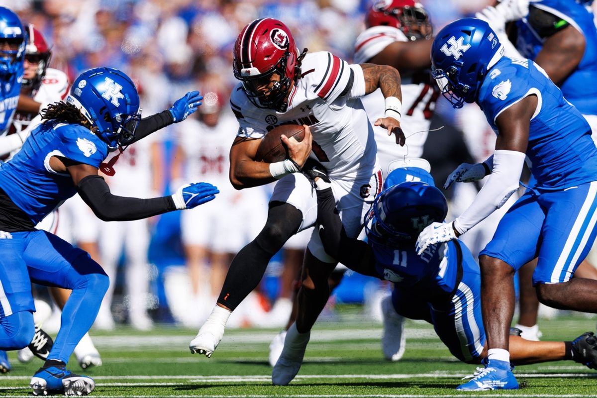 Sep 7, 2024; Lexington, Kentucky, USA; South Carolina Gamecocks quarterback Robby Ashford (1) carries the ball through Kentucky Wildcats defenders during the second quarter at Kroger Field. Mandatory Credit: Jordan Prather-Imagn Images