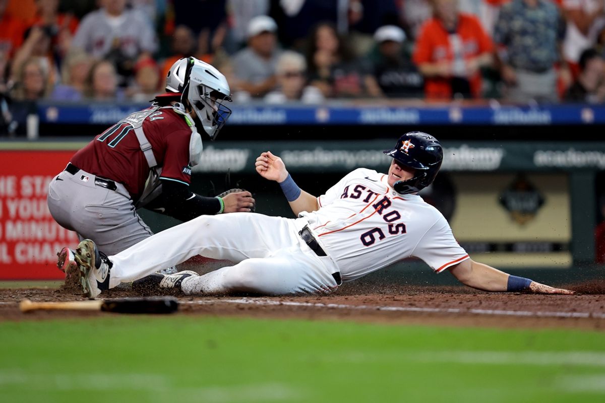 Sep 7, 2024; Houston, Texas, USA; Houston Astros center fielder Jake Meyers (6) slides across home plate to score a run against the Arizona Diamondbacks during the fourth inning at Minute Maid Park. Mandatory Credit: Erik Williams-Imagn Images