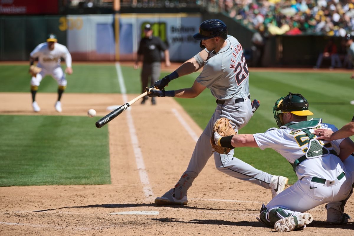 Sep 7, 2024; Oakland, California, USA; Detroit Tigers outfielder Parker Meadows (22) hits an RBI sacrifice fly against the Oakland Athletics during the seventh inning at Oakland-Alameda County Coliseum. Mandatory Credit: Robert Edwards-Imagn Images