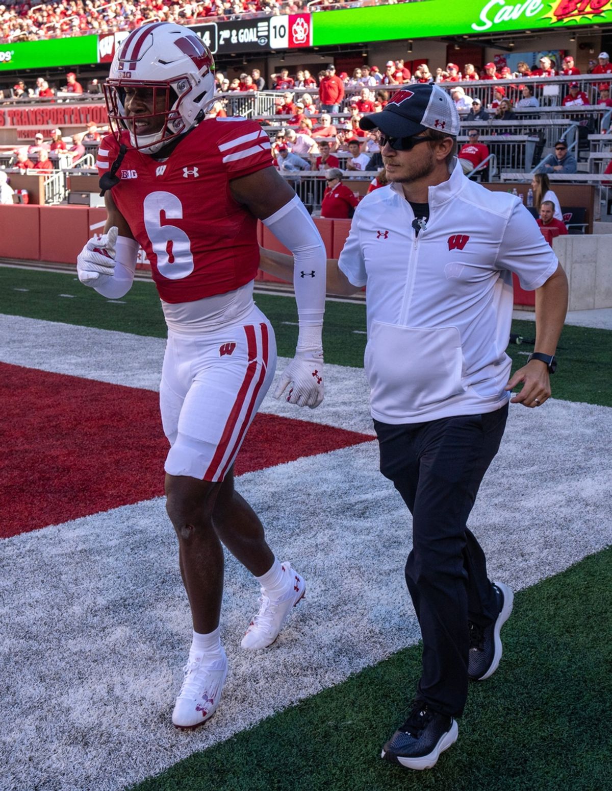 Wisconsin cornerback Xavier Lucas (6) is escorted by a member of the training staff during the fourth quarter of their game against South Dakota Saturday, September 7 , 2024 at Camp Randall Stadium in Madison, Wisconsin.