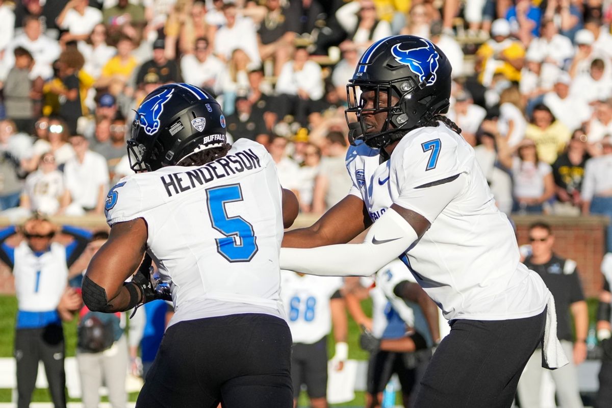 Sep 7, 2024; Columbia, Missouri, USA; Buffalo Bulls quarterback C.J. Ogbonna (7) hands off to running back Al-Jay Henderson (5) against the Missouri Tigers during the first half at Faurot Field at Memorial Stadium. Mandatory Credit: Denny Medley-Imagn Images