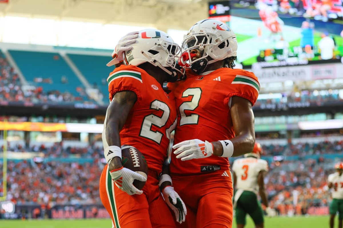 Sep 7, 2024; Miami Gardens, Florida, USA; Miami Hurricanes running back Chris Johnson Jr. (24) celebrates with wide receiver Isaiah Horton (2) after scoring a touchdown against Florida A&M Rattlers during the second quarter at Hard Rock Stadium. Mandatory Credit: Sam Navarro-Imagn Images