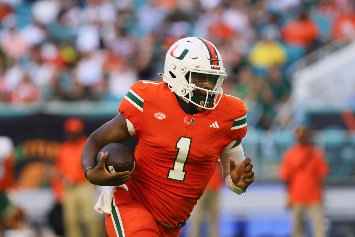 Sep 7, 2024; Miami Gardens, Florida, USA; Miami Hurricanes quarterback Cam Ward (1) runs with the football against the Florida A&M Rattlers during the second quarter at Hard Rock Stadium. Mandatory Credit: Sam Navarro-Imagn Images