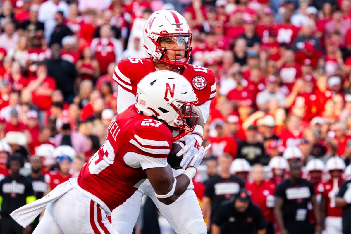 Sep 7, 2024; Lincoln, Nebraska, USA; Nebraska Cornhuskers quarterback Dylan Raiola (15) hands the ball off to running back Dante Dowdell (23) for a touchdown run against the Colorado Buffaloes during the first quarter at Memorial Stadium. Mandatory Credit: Dylan Widger-Imagn Images