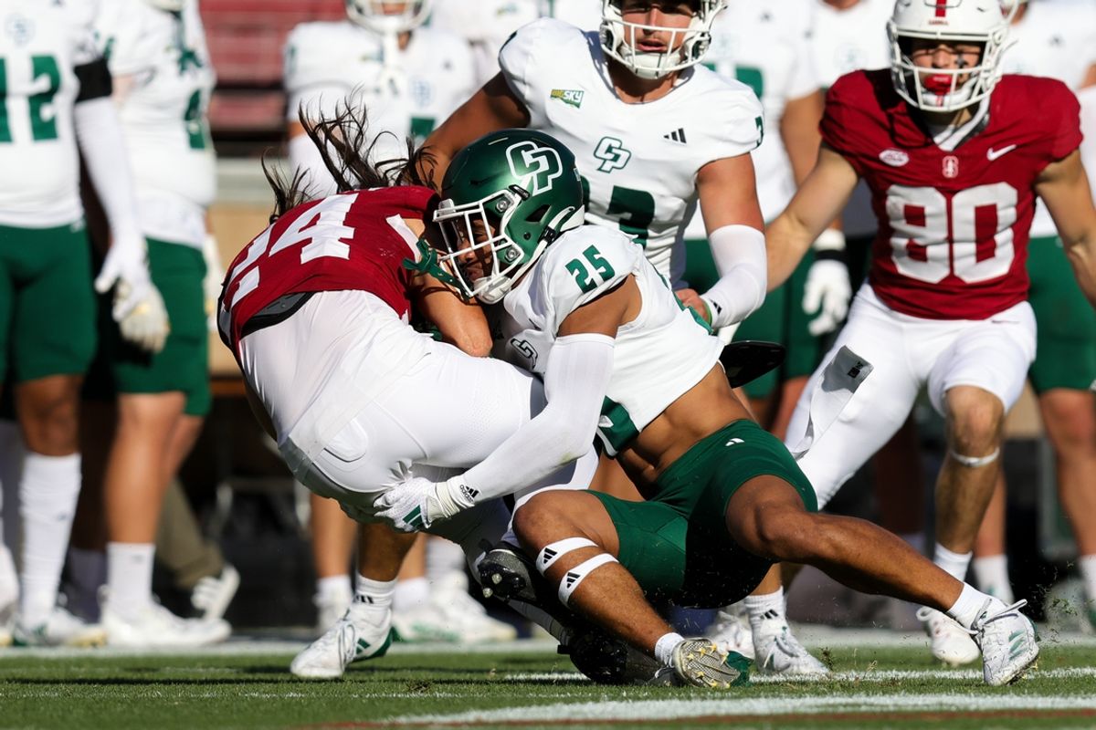 Sep 7, 2024; Stanford, California, USA; Stanford Cardinal wide receiver Tiger Bachmeier (24) is tackled by Cal Poly Mustangs safety Jeremy Justice (25) during the second quarter at Stanford Stadium. Mandatory Credit: Sergio Estrada-Imagn Images