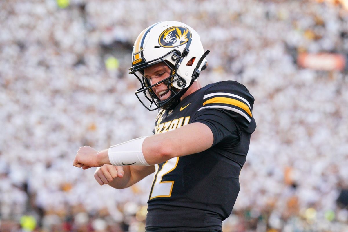 Sep 7, 2024; Columbia, Missouri, USA; Missouri Tigers quarterback Brady Cook (12) celebrates in the end zone after scoring against the Buffalo Bulls during the first half at Faurot Field at Memorial Stadium. Mandatory Credit: Denny Medley-Imagn Images
