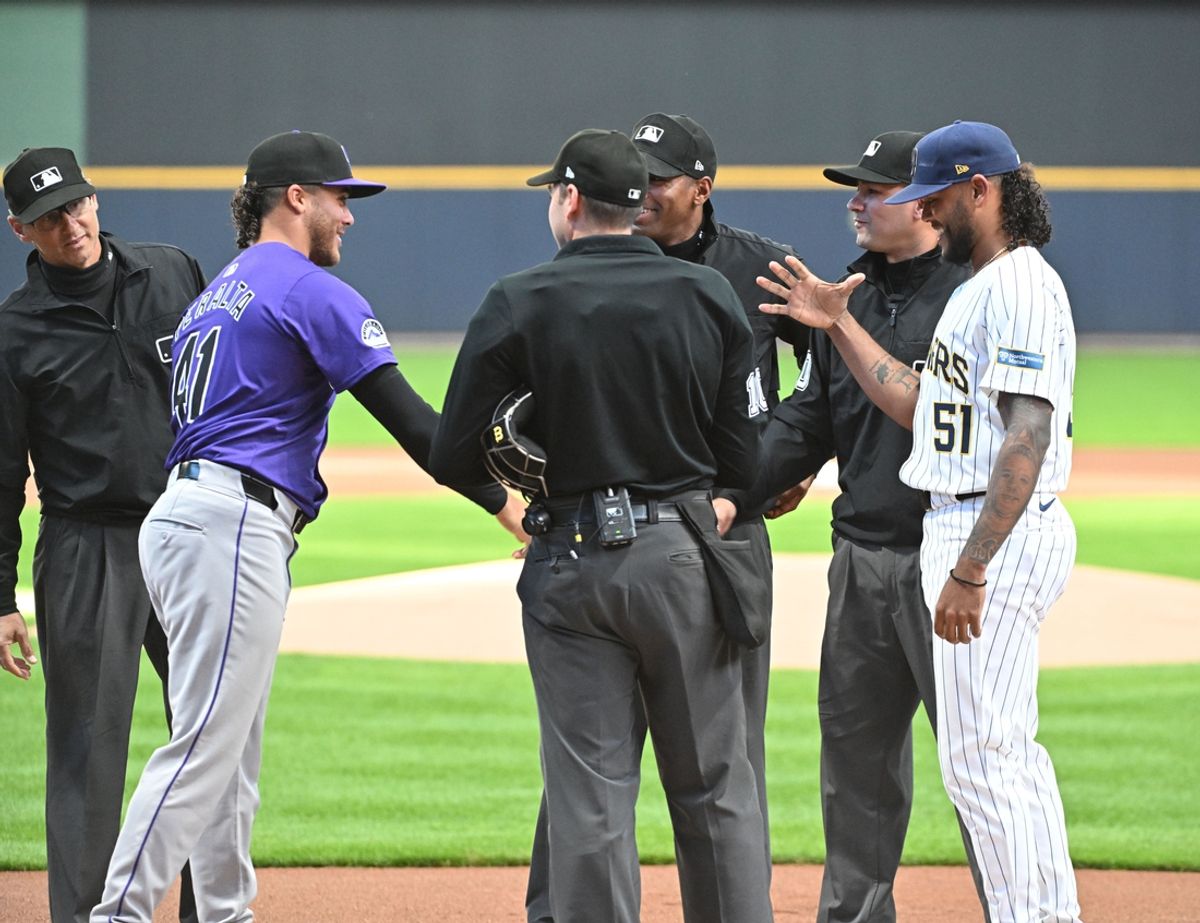 Sep 7, 2024; Milwaukee, Wisconsin, USA; Colorado Rockies pitcher Luis Peralta (41) and his brother Milwaukee Brewers pitcher Freddy Peralta (51) meet and home plate to exchange line up cards before their game at American Family Field. Mandatory Credit: Michael McLoone-Imagn Images