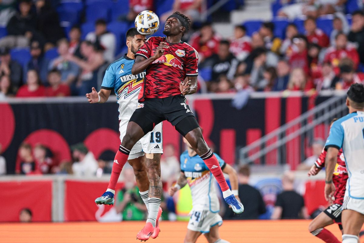 Sep 7, 2024; Harrison, New Jersey, USA; New York Red Bulls forward Cory Burke (7) and Sporting Kansas City defender Robert Castellanos (19) battles for a high ball during the first half at Red Bull Arena. Mandatory Credit: Vincent Carchietta-Imagn Images