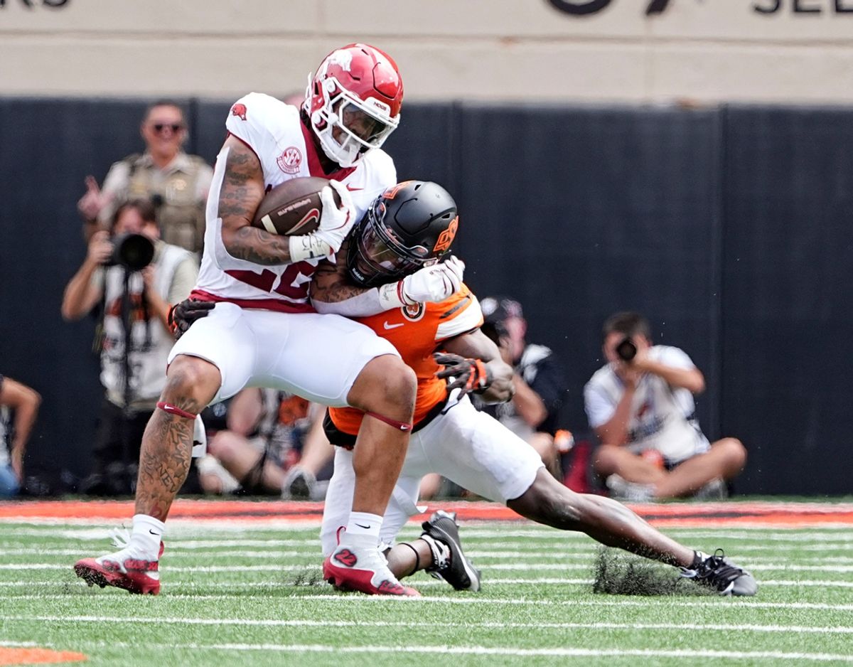 Oklahoma State's Nick Martin (4) tackles Arkansas' Ja'Quinden Jackson (22) first half of the college football game between the Oklahoma State Cowboys and the Arkansas Razorbacks at Boone Pickens Stadium in Stillwater, Okla.,, Saturday, Sept., 7, 2024.
