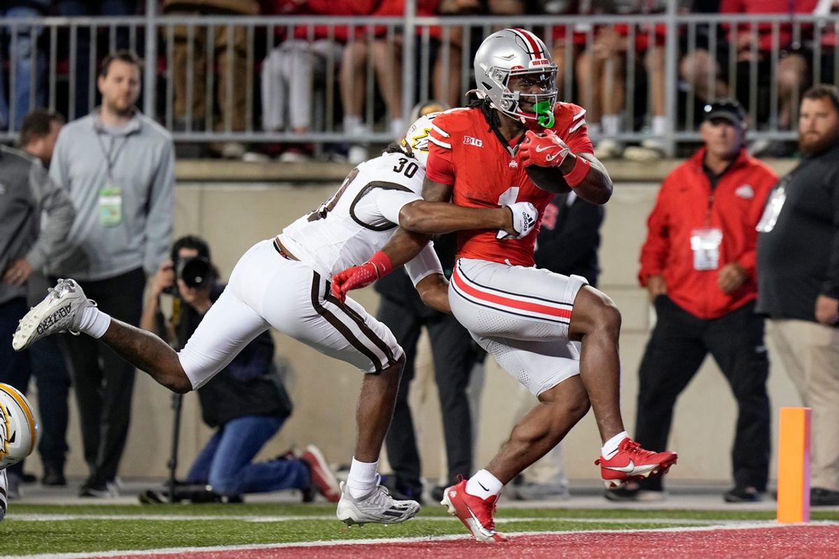 Sep 7, 2024; Columbus, Ohio, USA; Ohio State Buckeyes running back Quinshon Judkins (1) scores a touchdown as he's hit by Western Michigan Broncos safety Armani-Eli Adams (30) during the first half of the NCAA football game at Ohio Stadium.