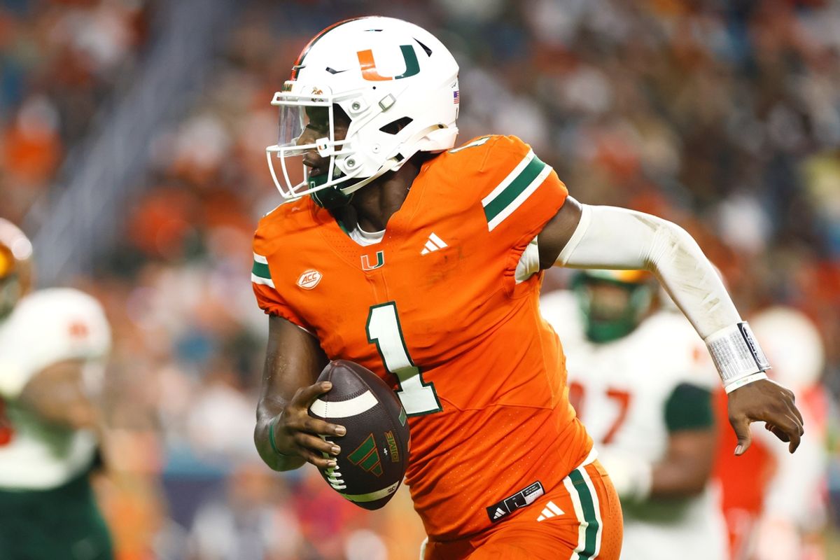 Sep 7, 2024; Miami Gardens, Florida, USA; Miami Hurricanes quarterback Cam Ward (1) runs with the football for a touchdown against the Florida A&M Rattlers during the third quarter at Hard Rock Stadium. Mandatory Credit: Sam Navarro-Imagn Images